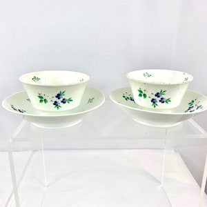 Soft paste porcelain handleless tea sipper cups and cooling bowls, painted with blue forget me nots. Matched pair, 18th century