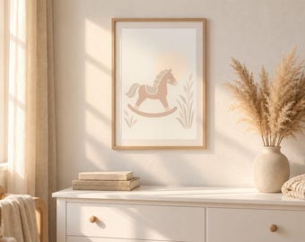 May include: A rectangular wall art print in a light wood frame featuring a tan rocking horse illustration centred against a pale background with a soft sun circle and stylised grass elements in muted earth tones.