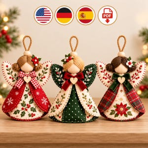 May include: Three handcrafted fabric angel ornaments with wooden bead heads and yarn hair. Each features embroidered wings, a small wooden heart charm, and festive patterns including holly, snowflakes, and poinsettias in red, green, and white.