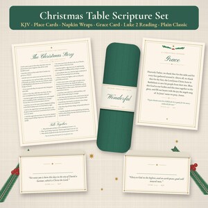 May include: A Christmas table scripture set featuring a reading card, a grace card, two place cards, and a dark green napkin wrap. The cards are cream-colored with gold borders and black text, including the Christmas story and prayers.