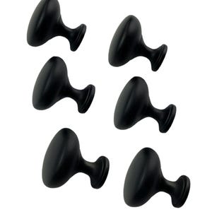 May include: Six black cabinet knobs with a round, slightly domed top and a short, cylindrical base.