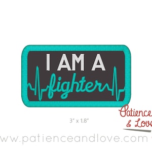 May include: Teal blue embroidered patch with a black background. The patch reads "I am a fighter" with a stylized heartbeat graphic. The patch measures 3 inches by 1.8 inches.