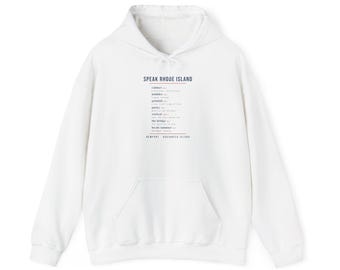 May include: A white hooded sweatshirt featuring a front graphic with the text Speak Rhode Island, followed by a list of local terms including cabinet, bubbler, grinder, packie, wicked, the bridge, and locals summer, with Newport Aquidneck Island below.