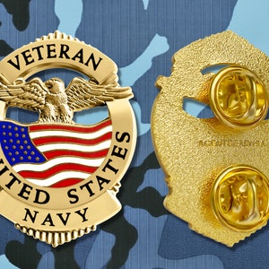 May include: Gold-colored United States Navy veteran pin with an eagle, American flag, and the words "Veteran", "United States", and "Navy".