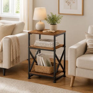 May include: A three-tier side table with a black metal frame and brown wood-grain shelves. The top shelf holds a white lamp and a small potted plant. The middle shelf contains stacked books, and the bottom shelf holds a woven basket.