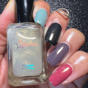 Starlight Polish Topaz over light green, black, purple, and pink - @crazy4polish0319