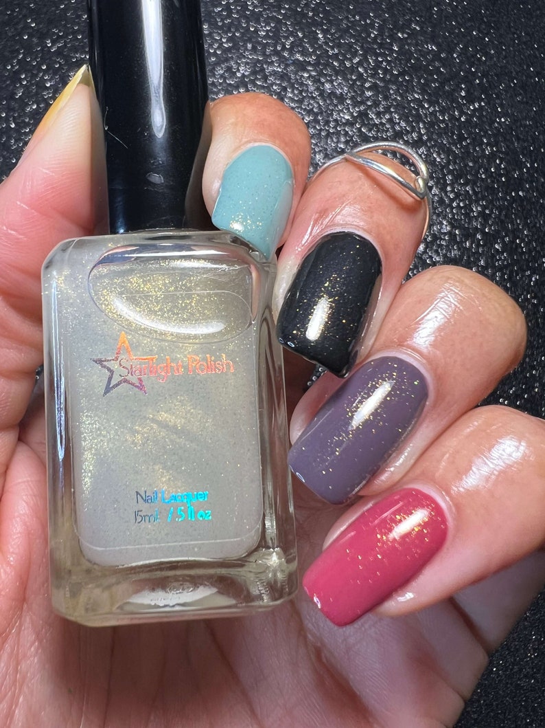 Starlight Polish Topaz over light green, black, purple, and pink - @crazy4polish0319