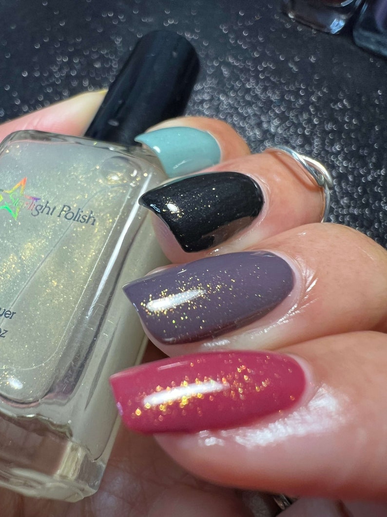 Starlight Polish Topaz over light green, black, purple, and pink - @crazy4polish0319