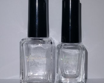 May include: Two clear glass bottles with black caps and a star-shaped logo that says "Sparkly Polish".