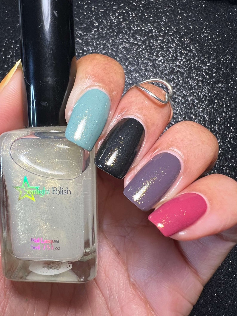 Starlight Polish Topaz over light green, black, purple, and pink - @crazy4polish0319