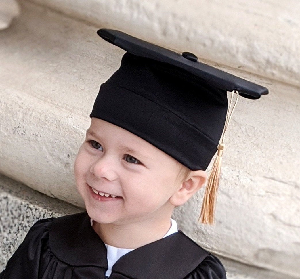 Baby Dressed In Graduation Attire Posing With Scroll Book Stock Photo -  Download Image Now - iStock