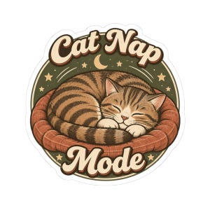 May include: A circular sticker featuring a brown tabby cat curled up asleep in a round, reddish-brown bed. The background is dark green with a crescent moon and stars. The text 'Cat Nap' is arched above the cat, and 'Mode' is below in a retro font.