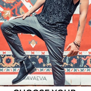 May include: A person wearing gray pants and a black tank top with a geometric pattern. The person is standing in front of a colorful patterned wall with the text "CHOOSE YOUR COLOR" at the bottom.