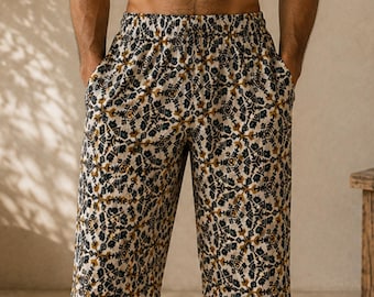 May include: Knee-length shorts featuring a repeating geometric pattern in shades of dark blue, mustard yellow, and cream. The shorts have an elasticized waistband and two side pockets, providing a relaxed fit with a straight-leg silhouette.