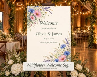 Può includere: Un cartello di benvenuto per matrimonio rettangolare con illustrazioni ad acquerello di fiordalisi blu, cosmee rosa e lavanda. Il testo recita Welcome to the wedding of Olivia & James, May 22, 2027, e We're so glad you're here su sfondo bianco.