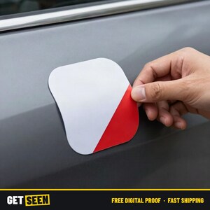 May include: A square-shaped decal with rounded corners featuring a diagonal split design. The top-left section is solid white, while the bottom-right section is solid red. The decal is shown being applied to a smooth, gray metallic surface.