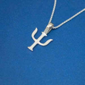 May include: A silver necklace with a pendant shaped like the Greek letter Psi. The necklace is on a blue background.