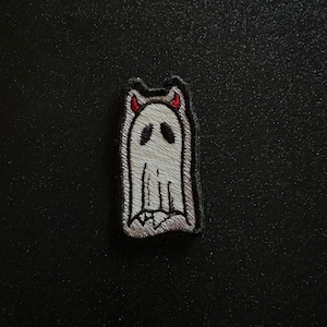 May include: White embroidered ghost with red devil horns, a Halloween themed patch.