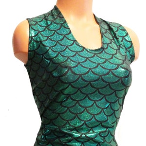 May include: Green and black mermaid-scale print spandex shorts with a sleeveless top. The fabric has a shiny, iridescent finish.