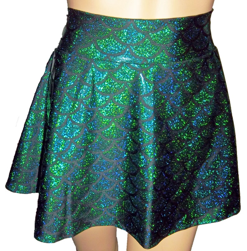 May include: A black and green skater skirt with a mermaid scale pattern. The skirt is made of a shiny, iridescent fabric.
