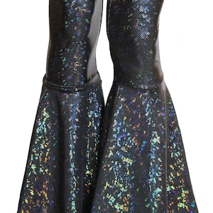 May include: Black flared pants with a iridescent finish. The pants have a wide leg opening and a fitted waist.