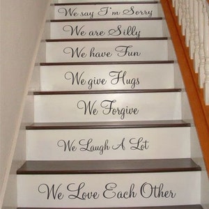 May include: A staircase with white risers featuring black vinyl lettering. The text reads: In this house, We are Real, We make Mistakes, We say I'm Sorry, We are Silly, We have Fun, We give Hugs, We Forgive, We Laugh A Lot, We Love Each Other, We are Family.