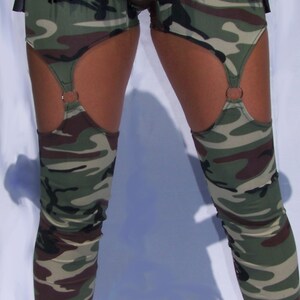 May include: Camouflage leggings with a black fringe waistband and garter straps with metal rings.