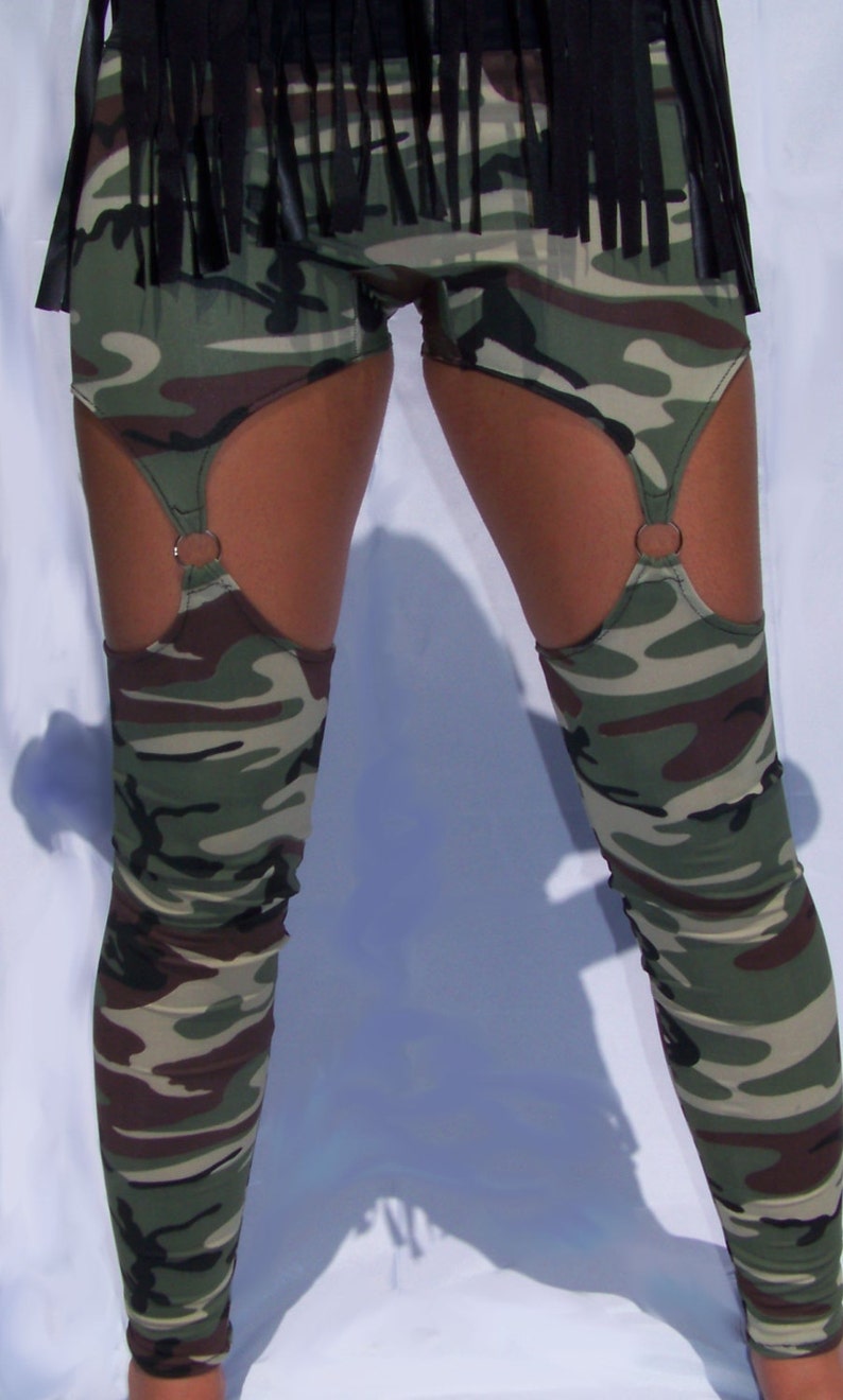 May include: Camouflage leggings with a black fringe waistband and garter straps with metal rings.