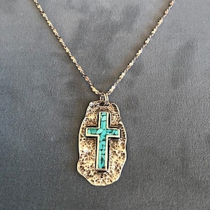 Turquoise cross pendant on a hammered silver shield - Navajo made.