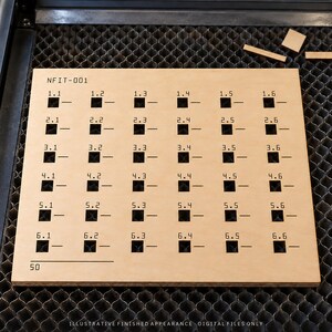 May include: A square light-colored wooden test board labeled NFIT-001 featuring a grid of thirty-six numbered square cutouts from 1.1 to 6.6, each with a small horizontal line next to it, and the number 50 printed in the bottom left corner.