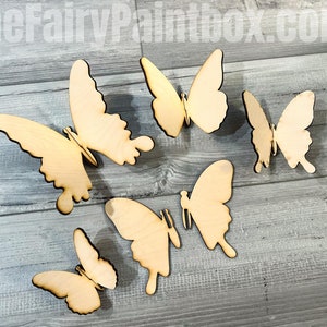 May include: Five unfinished wooden butterfly shapes, perfect for crafting and decorating. The butterflies are various sizes and are arranged on a light wood surface.