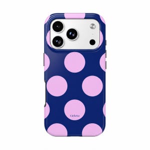 May include: A dark blue smartphone case featuring a repeating pattern of large, light pink polka dots. The case has a rectangular cutout for the camera lenses and the word Gioletta is printed in small, dark letters on one of the pink dots.