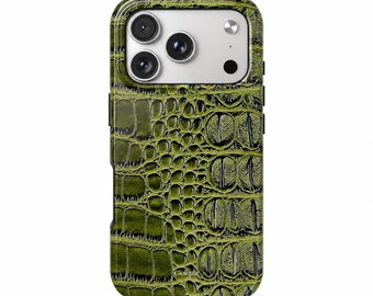 May include: A smartphone case featuring a textured olive green crocodile skin pattern. The case has a rectangular camera cutout at the top with three circular lenses and a flash. The word Gioletta is printed in small white letters at the bottom.