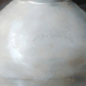 Close-up of the moon jar print: the rim and crackled white glaze of the jar with a faint band around its middle.