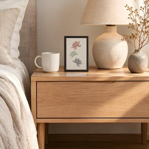 Peony print in the 4x6 inch size on a bedside table next to a ceramic lamp; the frame shown is not included.