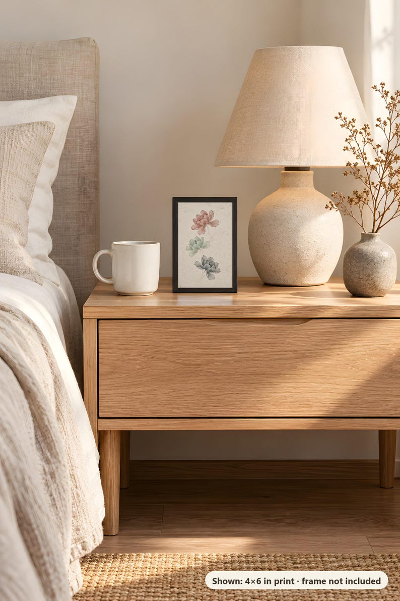 Peony print in the 4x6 inch size on a bedside table next to a ceramic lamp; the frame shown is not included.