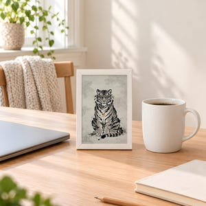 Korean tiger print in the 4x6 inch size standing on a wooden desk next to a coffee mug; the frame shown is not included.
