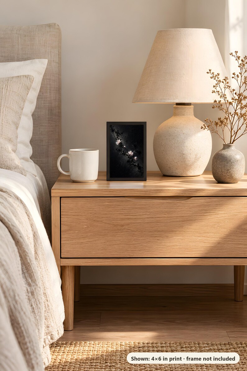 Plum blossom design printed in the 4x6 inch size on a bedside table next to a ceramic lamp; the frame shown is not included.