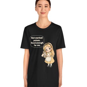 May include: A black t-shirt featuring a graphic of a blonde character in a yellow dress and white apron holding a glass bottle. A speech bubble above the character contains the text: Not marked poison. Good enough for me.