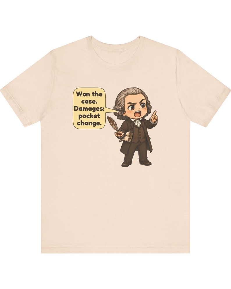 May include: A light beige t-shirt featuring a cartoon illustration of a historical figure in a brown suit holding a quill. A speech bubble next to the character contains the text: Won the case. Damages: pocket change.