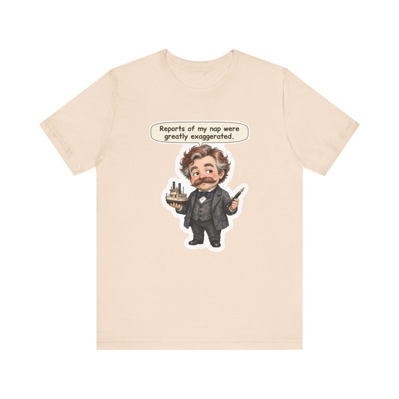 Watercolor chibi Mississippi riverboat author with a bushy moustache, navy bow tie and charcoal suit, holding a model riverboat and a fountain pen, with the speech bubble "Reports of my nap were greatly exaggerated." printed on a tee