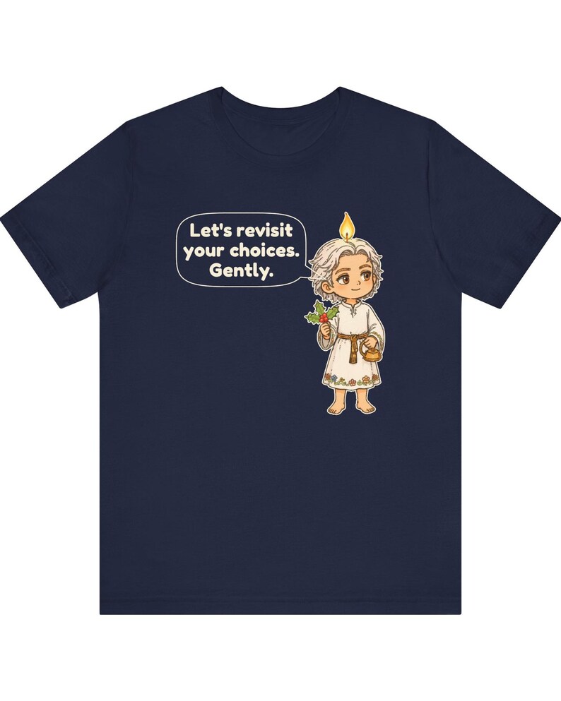 May include: A navy blue t-shirt featuring a cartoon character with a candle flame on their head, holding a sprig of holly and a small teapot. A speech bubble contains the text: Let's revisit your choices. Gently.