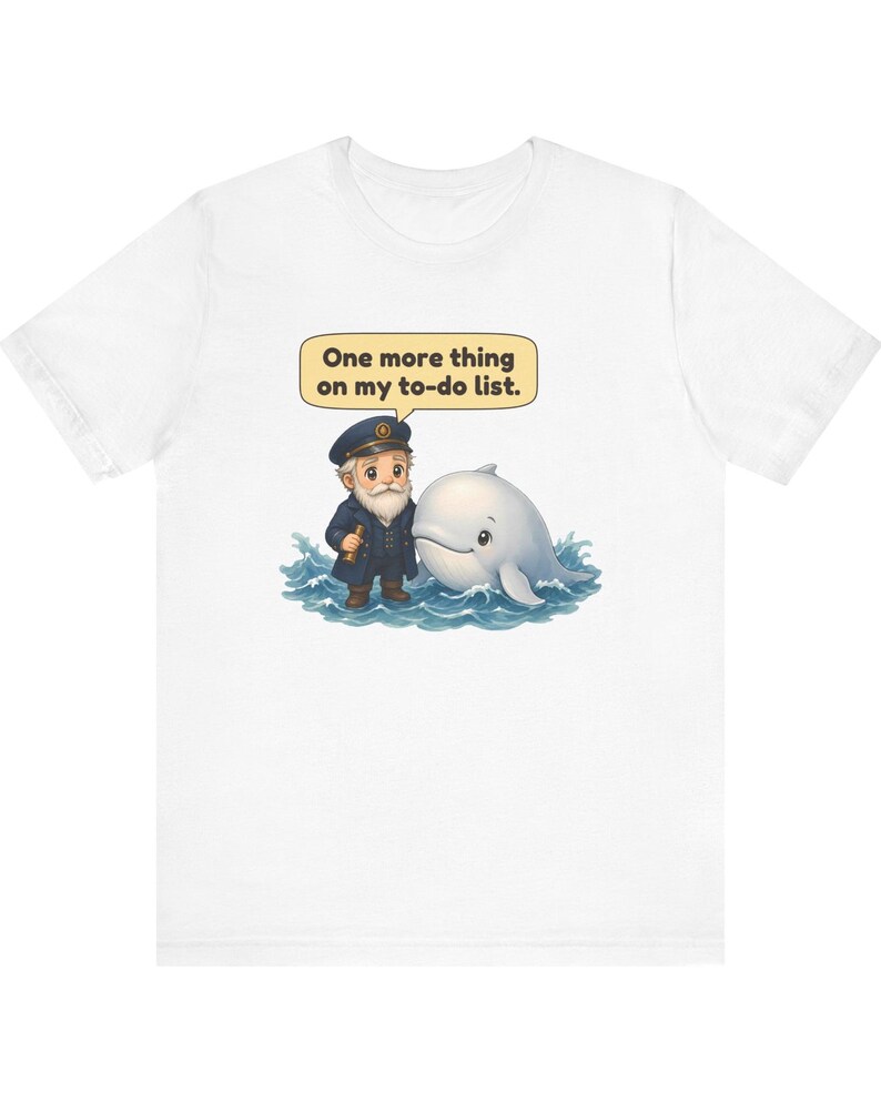 May include: A white t-shirt featuring a graphic of a bearded sea captain in a navy uniform standing in blue ocean waves next to a white whale. A yellow speech bubble above the captain contains the text, One more thing on my to-do list.