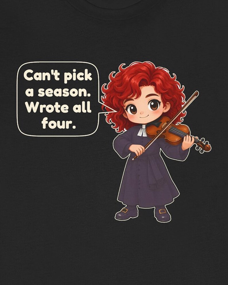 May include: A black t-shirt featuring a cartoon illustration of a red-haired character playing a wooden violin. A speech bubble contains the text: Can't pick a season. Wrote all four. The character wears a dark purple long-sleeved robe with a white collar.