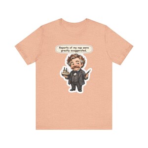 Watercolor chibi Mississippi riverboat author with a bushy moustache, navy bow tie and charcoal suit, holding a model riverboat and a fountain pen, with the speech bubble "Reports of my nap were greatly exaggerated." printed on a tee