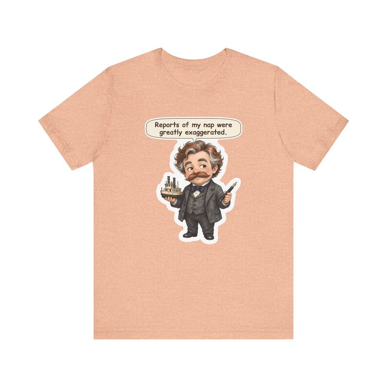 Watercolor chibi Mississippi riverboat author with a bushy moustache, navy bow tie and charcoal suit, holding a model riverboat and a fountain pen, with the speech bubble "Reports of my nap were greatly exaggerated." printed on a tee