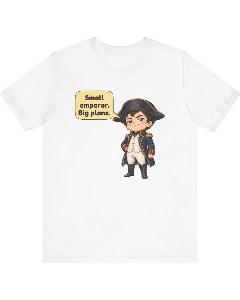 May include: A white t-shirt featuring a graphic of a cartoon character dressed in a historical military uniform with a bicorne hat. Next to the character is a speech bubble containing the text: Small emperor. Big plans.