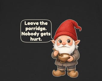 May include: A black t-shirt featuring a graphic of a gnome wearing a red hat, holding a wooden bowl of porridge with a spoon. A speech bubble next to the gnome contains the text: Leave the porridge. Nobody gets hurt.