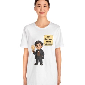 Może przedstawiać: Biały t-shirt z rysunkową ilustracją osoby w ciemnym garniturze i brązowej kamizelce, trzymającej świecącą żar&oacute;wkę. Dymek zawiera tekst: I lit the room. You're welcome.