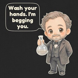 May include: A black t-shirt featuring a cartoon illustration of a man with a beard in a gray suit and bow tie, holding a glass flask. A speech bubble above him contains the text: Wash your hands. I'm begging you.
